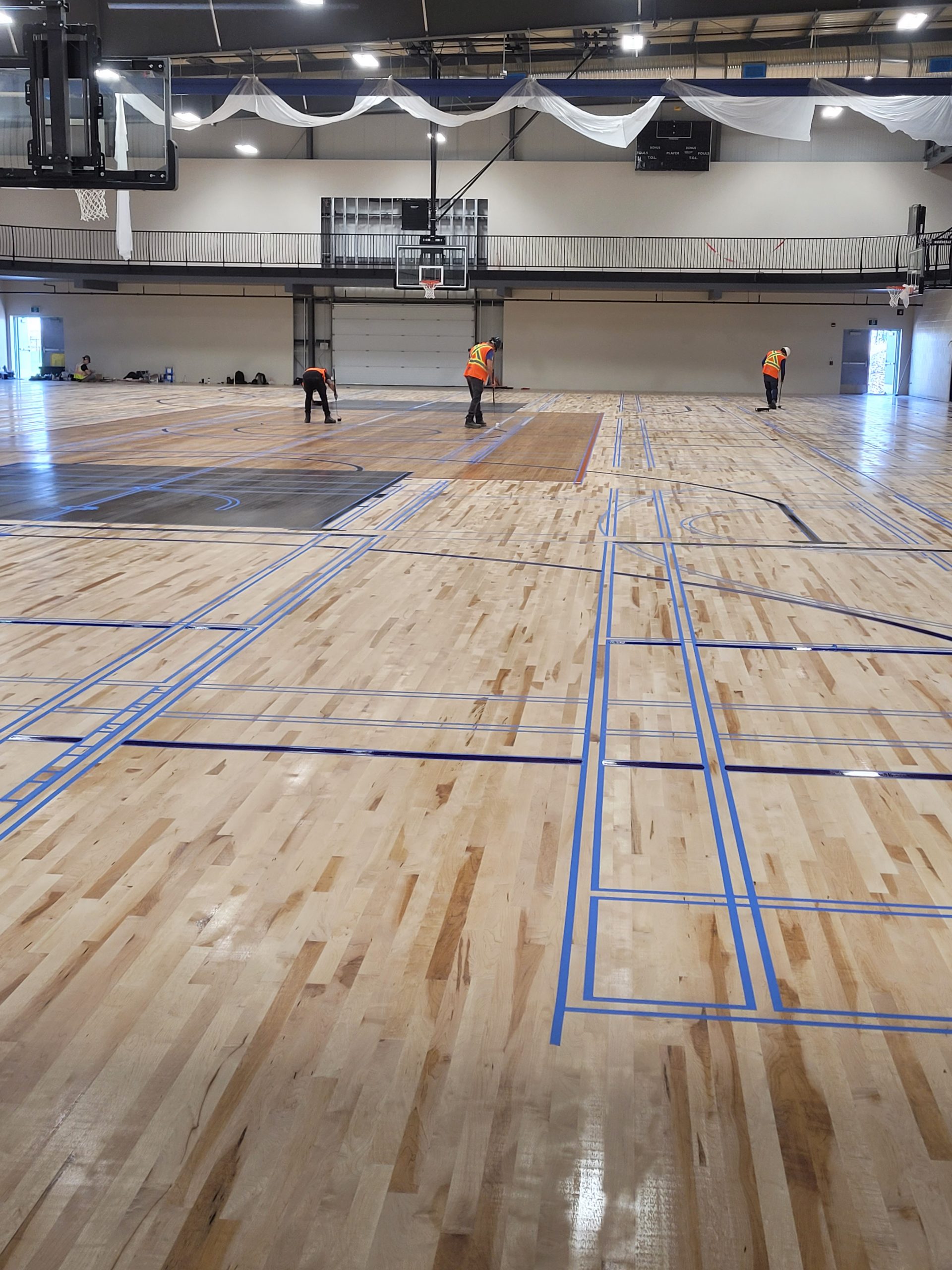 June 2021 - Fieldhouse floor is being prepared for lines!